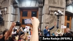 Protesters rally against threats to journalists in Serbia in front of government headquarters in Belgrade on October 16.