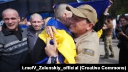 A Ukrainian POW is hugged after being released in a prisoner exchange with Russia, which took place at Ukraine's border with Belarus on May 23. 