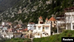 Syria -- A general view shows a church among residential buildings in the Armenian Christian town of Kasab after rebel fighters seized it, March 24, 2014