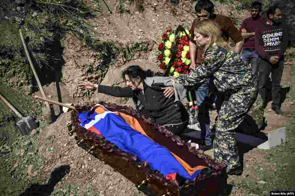 A mother mourns her son, draped in the flag of Nagorno-Karabakh, which is internationally recognized as Azerbaijani territory but is mostly populated by ethnic Armenians, during his funeral in Stepanakert on October 17.