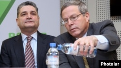 Armenia - Prime Minister Tigran Sarkisian (L) and U.S. Ambassador John Heffern attend a conference on pension reform, Yerevan, 21Feb2014.