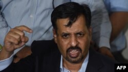 Former Mayor of the southern Pakistan city of Karachi Mustafa Kamal gestures while speaking to media representatives after his return from self-imposed exile in Karachi on March 3.