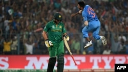 India's Hardik Pandya (R) celebrates after his dismissal of Pakistan's captain Shahid Afridi (L) during the World T20 cricket tournament on March 19.