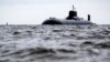 U.S. military officials told reporters that the submarine surfaced during a war-game exercise. (file photos)