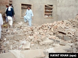 Hayatullah Khan's photo from December 2005 shows local tribesmen inspecting the debris of a house in Mir Shan after an alleged drone attack that killed senior Al-Qaeda commander Abu Hamza Rabia.