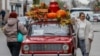 A woman poses with a retro VAZ 2101 car during the annual BRICS summit in Kazan, Russia.