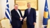 Greek Foreign Minister Nikos Kotzias (left) shakes hands with Kosovar President Hashim Thaci in Pristina on April 12.