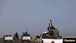 Rebels travel in a convoy on their way to Sirte.