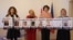 З партрэтамі замежнікаў-палітзьняволеных: мэдыяэкспэртка Ганна Любакова, каардынатарка беларускай народнай амбасады ў Шатландыі Ірына МакЛейн, праваабаронца Анастасія Васільчук, дырэктарка Офісу дэмакратычных сіл Беларусі ў Чэхіі Крысьціна Шыянок. Ілюстрацыйнае фота 