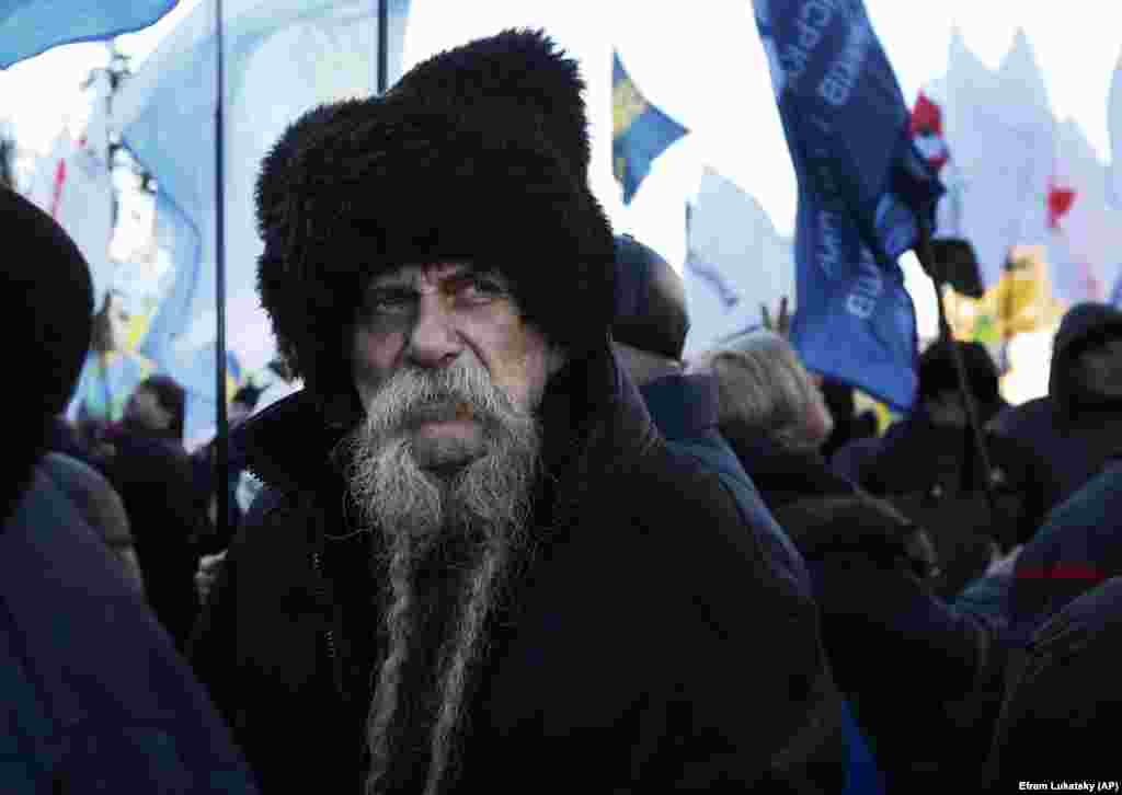 A protester looks on during a rally in front of the parliament building in Kyiv to protest changes to laws governing the sale of farmland. (AP/Efrem Lukatsky)