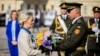 European Commission President Ursula von der Leyen (left) is given a bouquet of flowers to place at a wall in Kyiv commemorating the fallen Ukrainian soldiers in the war with Russia on September 20.