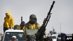 Rebel fighters leave the town of Ajdabiya on April 6.