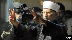 Tahir-ul Qadri flashes victory signs during a protest rally in Islamabad in January 2013.