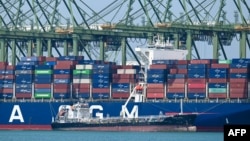Un petrolier realimentează un vas container ancorat în terminalul portuar Pasir Panjang din Singapore, pe 10 martie 2026.