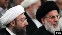 Ayatollah Sadeq Larijani (left) and outgoing judiciary chief Ayatollah Mahmud Hashemi-Shahrudi at Larijani's induction on August 17