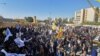 Protesters and militia fighters gather to condemn air strikes on bases belonging to Hashd al-Shaabi (paramilitary forces), outside the main gate of the U.S. Embassy in Baghdad. December 31, 2019