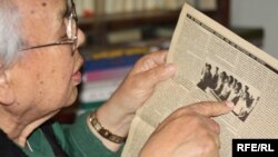 Zhumaghali Ismagulov, former director KazTAG, showing the reports that raised the Soviet ire, in a December 2009 photograph.