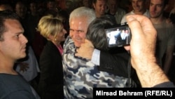 Zivko Budimir (facing camera, embracing a well-wisher after his release from prison in Mostar in May) and six other people are accused of arranging the pardons of 27 people without appropriate legal reasons to do so.