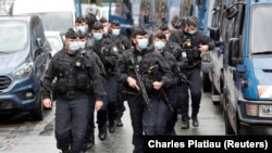 French soldiers at the scene of a knife attack near the former offices of satirical newspaper Charlie Hebdo in Paris on September 25.