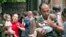 A soldier carries a baby after the hostage-takers released 26 women with their children from the Beslan siege on September 2, 2004.