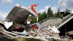 In the Bryansk region, which borders Belarus and Ukraine, a passenger train was struck by debris from an overpass around 11 p.m. local time, the national Investigative Committee said in a statement.