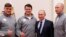 President Vladimir Putin (second left) poses for a selfie during a meeting on January 31 with Russian athletes and team members who will take part in the upcoming Winter Olympic Games as neutral athletes.