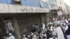 Angry customers wait outside the Kabul Bank in the Afghan capital on September 5.