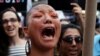 U.S. -- A participant cries during a protest against U.S. President Donald Trump's announcement that he plans to reinstate a ban on transgender individuals from serving in any capacity in the U.S. military, on Times Square, in New York, July 26, 2017