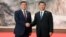 Then-Kyrgyz President Sooronbai Jeenbekov (left) and Chinese President Xi Jinping met on the sidelines of the Shanghai Cooperation Organization summit in Qingdao in June 2018.