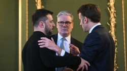 Ukrainian President Volodymyr Zelenskyy, UK Prime Minister Keir Starmer, and French President Emmanuel Macron embrace after holding a meeting during a summit in London on March 2.
