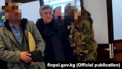 Adamkul Junusov (center) was extradited from Azerbaijan on December 28.