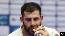 Arman Adamian celebrates with his gold medal at the World Judo Championships in Doha, Qatar, on May 12.