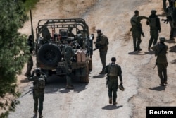 Israeli soldiers gather on their country's side of the Israel-Lebanon border on March 16 amid an escalation in the conflict with Hezbollah.