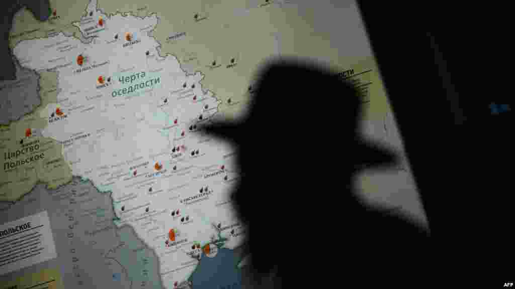 A visitor is silhouetted against a map in the Jewish Museum in Moscow, which opened on November 8.