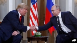 U.S. President Donald Trump and Russian President Vladimir Putin shake hands at the beginning of a meeting at the Presidential Palace in Helsinki, Finland, on July 16, 2018, during Trump's first term.