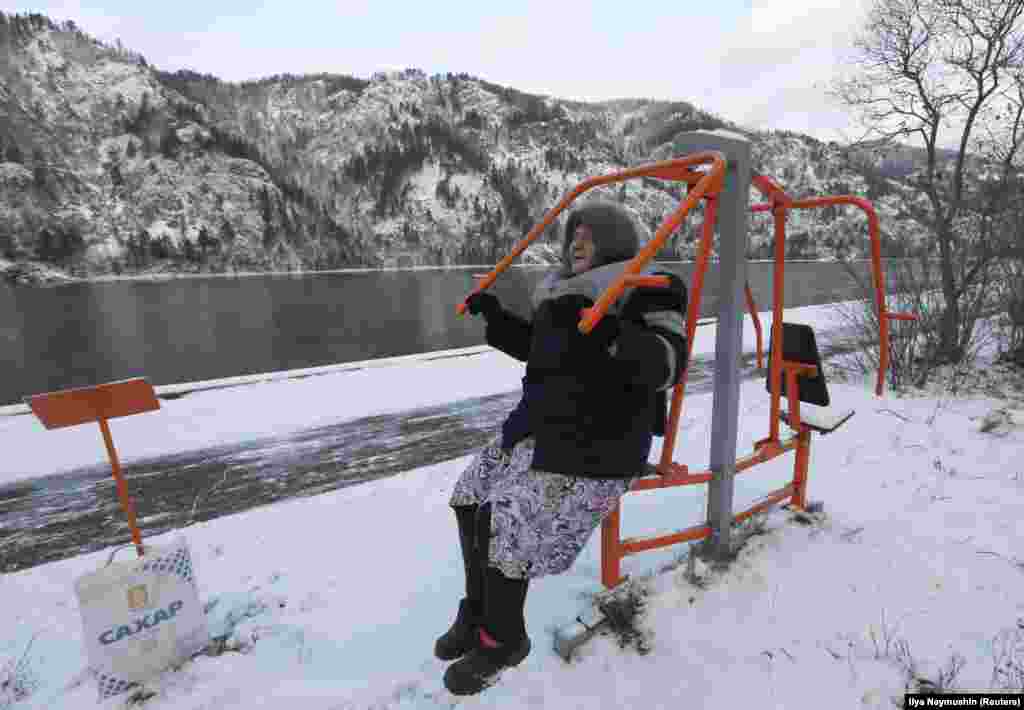 Antonina Yermokhina, 86, does physical exercises during her daily training session on the embankment of the Yenisei River in the Siberian town of Divnogorsk. (Reuters/Ilya Naymushin)