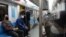 People wear protective face masks, following the outbreak of coronavirus, as they sit in a metro in Tehran, March 17, 2020