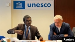 UNESCO's deputy director-general for culture, Ernesto Ottone Ramirez (right) and the cultural agency's director of world heritage, Lazare Eloundou Assomo, take part in a news conference about Ukraine's endangered cultural heritage in Paris on April 1. 