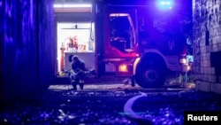 An emergency worker rests after extinguishing a fire in an apartment building following a Russian drone attack in Kyiv on May 4.