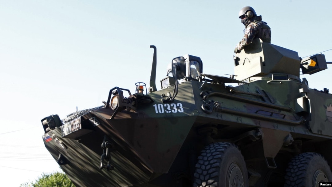 KFOR soldiers from Slovenia observe an area in the village of Rudare near Mitrovica 