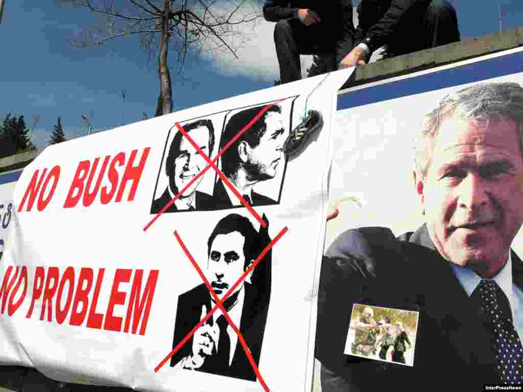 Protesters gather on March 25 near a banner hanging over a sign marking George W. Bush Street in Tbilisi. - Many are unhappy that a street in the Georgian capital has been renamed in honor of the former U.S. president. Photo by Inter Press News