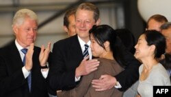 Former President Bill Clinton (left) and Vice President Al Gore greet freed journalists Laura Ling and Euna Lee (right) upon their arrival in the United States.