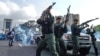 Members of the Bolivarian National Guard who joined Venezuelan opposition leader and self-proclaimed acting president Juan Guaido fire into the air to repel forces loyal to President Nicolas Maduro. April 30, 2019