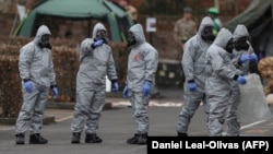 Military personnel wearing protective clothing work in areas that are feared to be contaminated with Novichok in Salisbury, England, on March 11.