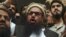 Pakistani head of the Jamaat-ud-Dawa organization Hafiz Saeed speaks to the media after his release order outside a court in Lahore on November 22.