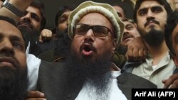 The head of the Pakistani Jamaat-ud-Dawa organization, Hafiz Saeed, speaks to the media after his release order outside a court in Lahore on November 22.