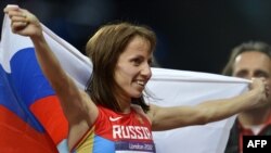 Russian runner Maria Savinova-Farnosova celebrates after winning the women's 800-meter final at the London 2012 Olympic Games in August 2012.