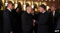 French President Emmanuel Macron (right) speaks with Armenian Prime Minister Nikol Pashinyan during a walk on a Yerevan street on May 3.