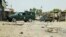 Pakistani troops guard the site of a suicide attack at an election rally in Bannu on July 13.