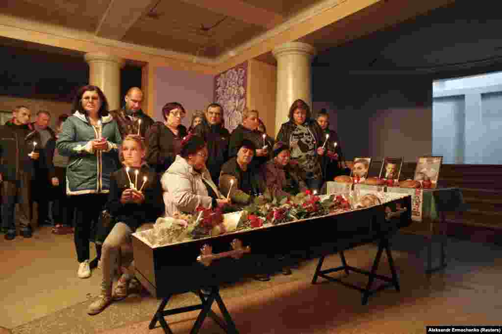 Family and friends mourn during a memorial service before the funeral of three teenage boys --ages 13 to 15 -- who were killed in a land-mine explosion in Horlivka near Donetsk in eastern Ukraine. Horlivka Mayor Ivan Prikhodko said the boys had gone for a walk, adding, &ldquo;They found an abandoned house and were just looking for adventure.&quot; (Reuters/Alexander Ermochenko)